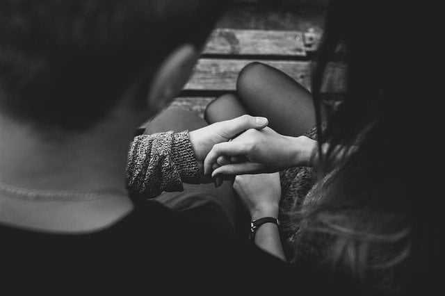 Black and white photo of a couple holding hands at a drug and alcohol rehab centre in Hertfordshire