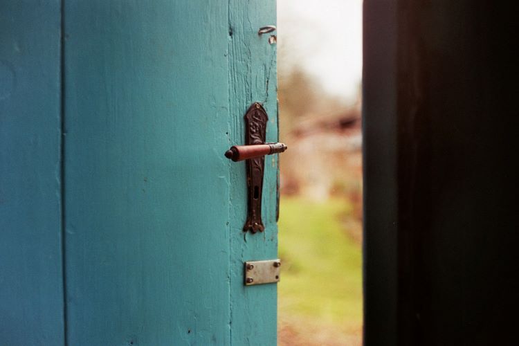 A blue door slightly ajar