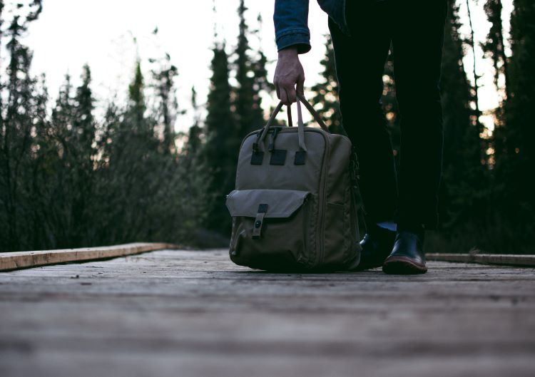 A person carrying a bag in Bristol