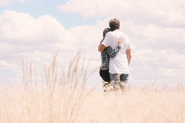 Couple hugging in a field outside of a drug and alcohol rehab in Durham