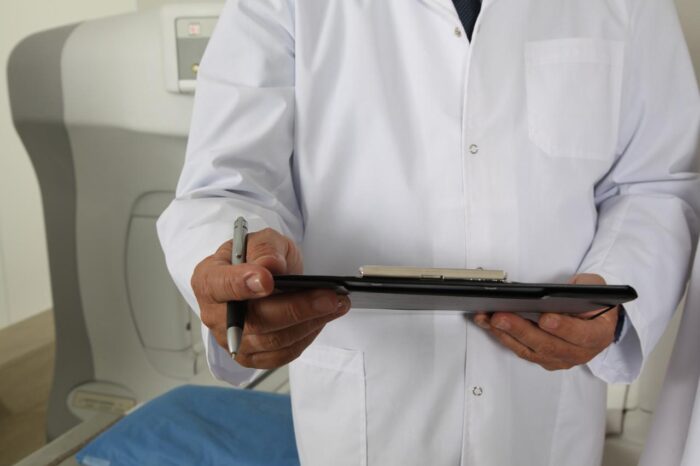 Doctor holding a clipboard at a drug and alcohol rehab in Devon