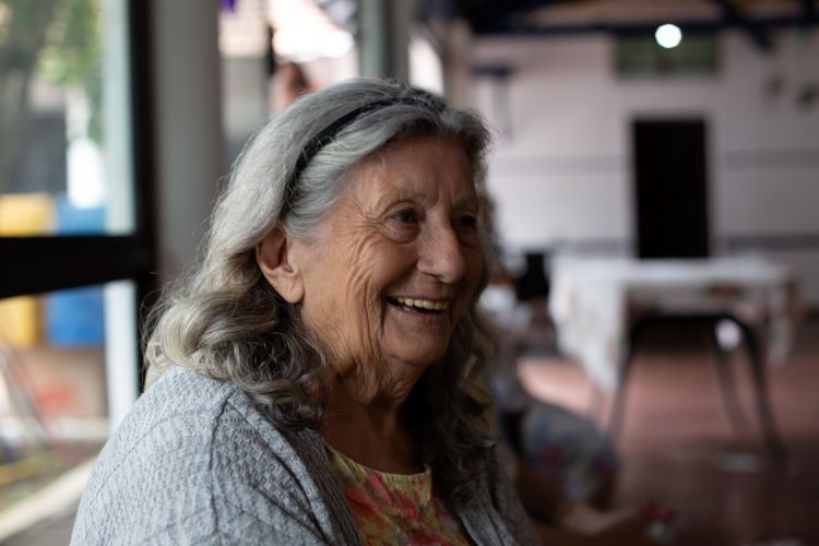 Older woman laughing at a drug and alcohol rehab in Norfolk