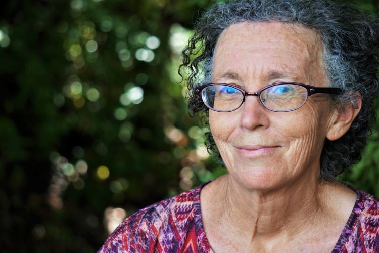 Older woman standing in a garden at a drug and alcohol rehab in Norfolk