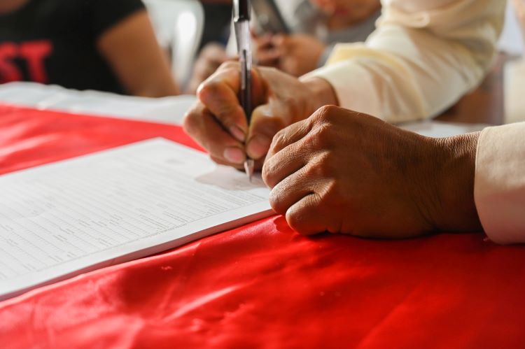 A person signing paperwork