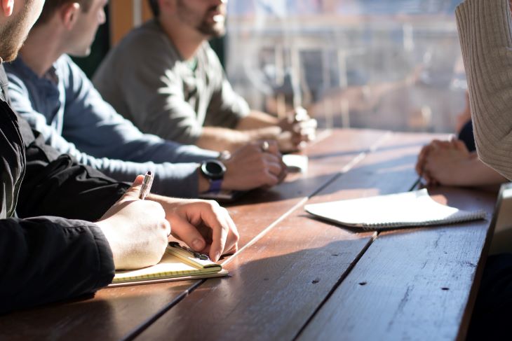 Support group taking notes at a drug and alcohol rehab in Luton