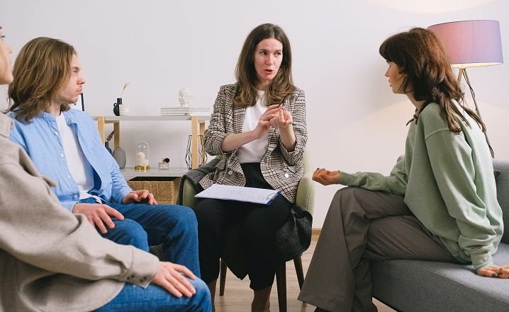 Therapist speaking to a group of patients at a drug and alcohol rehab clinic in Devon or near Devon