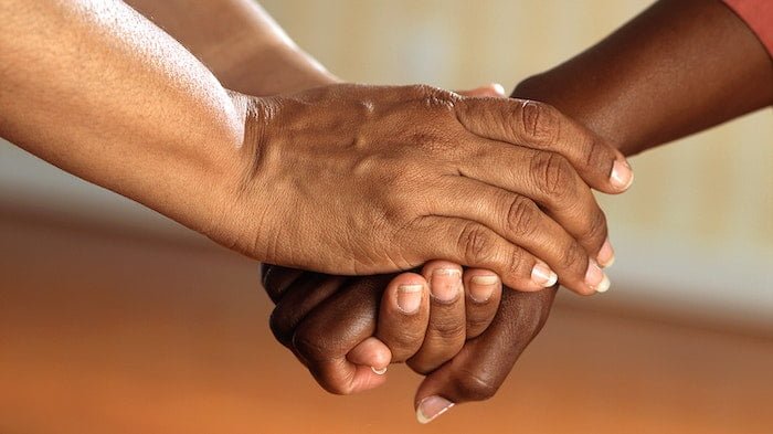 Two people holding hands at a drug and alcohol rehab centre in Dorset