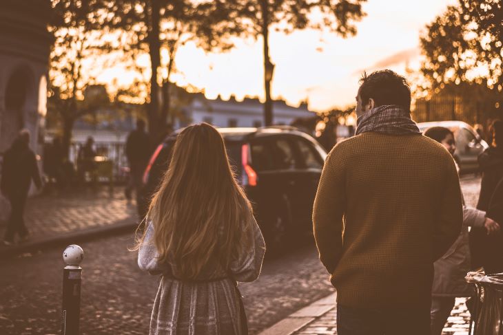 A man and woman walking down a street at dusk in Wolverhampton