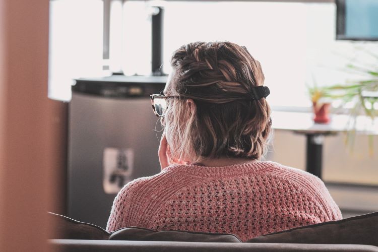 Woman looking concerned in the kitchen of a residential drug and alcohol rehab centre in Norfolk