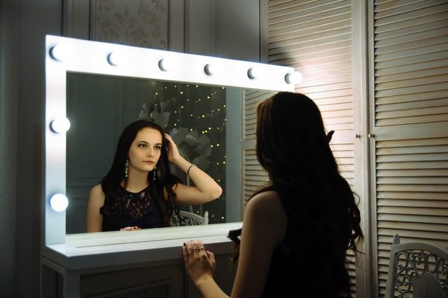Woman looking in a mirror at a drug and alcohol rehab in Lincolnshire