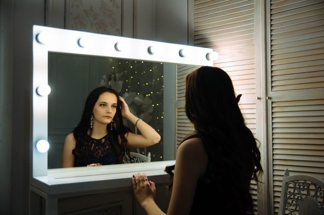 Woman looking into a mirror at rehab in Birmingham