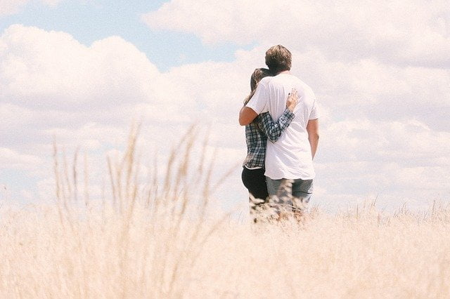 Couple hugging in a field on the outskirts of London
