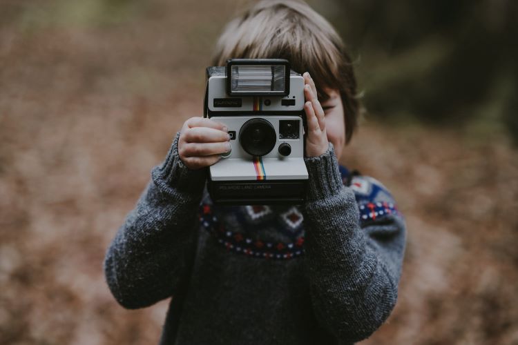 A child holding a camera