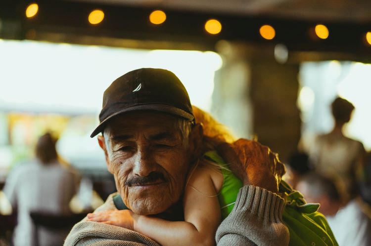 Elderly man hugging a little girl