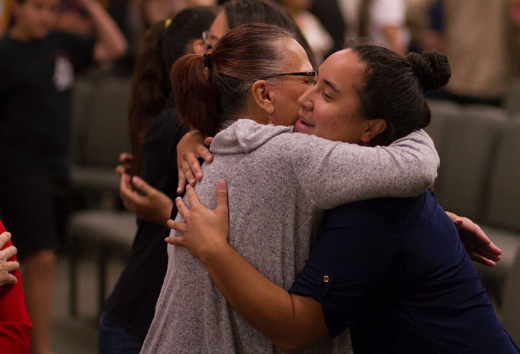 Two women hugging in rehab in Coventry