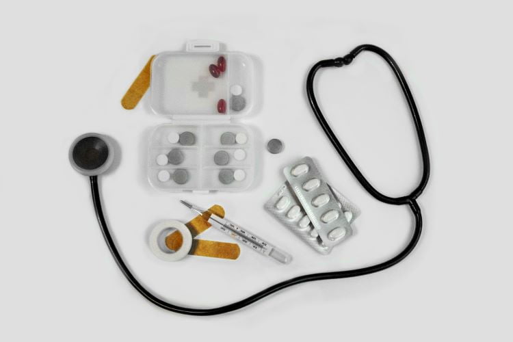 A stethoscope, pill packets and medical equipment
