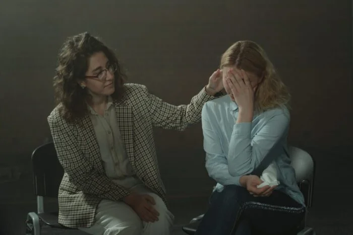 Patient being comforted by a therapist at a drug and alcohol rehab clinic in Lancaster