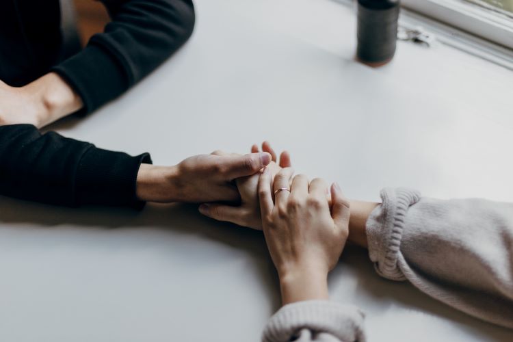 Two people holding hands in West Sussex