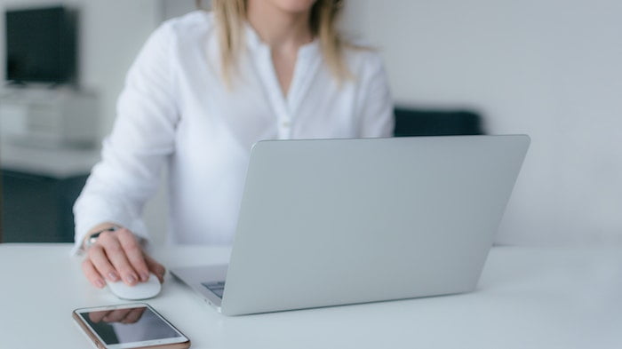 Woman working on a laptop at a drug and alcohol rehab clinic in Hemel Hempstead