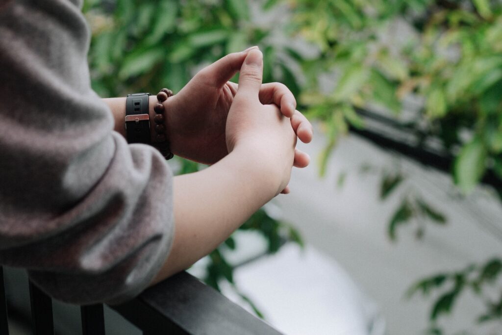 A person with their hands clasped