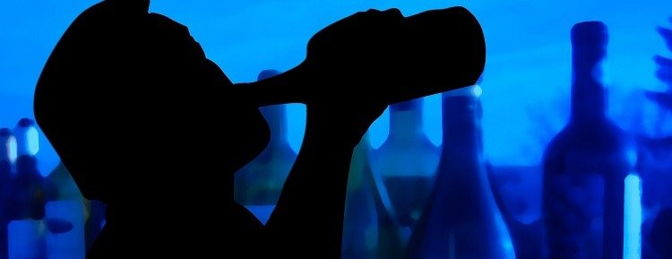 Silhouette of a man drinking alcohol