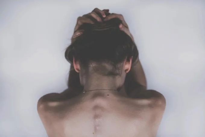 Woman bent over in pain