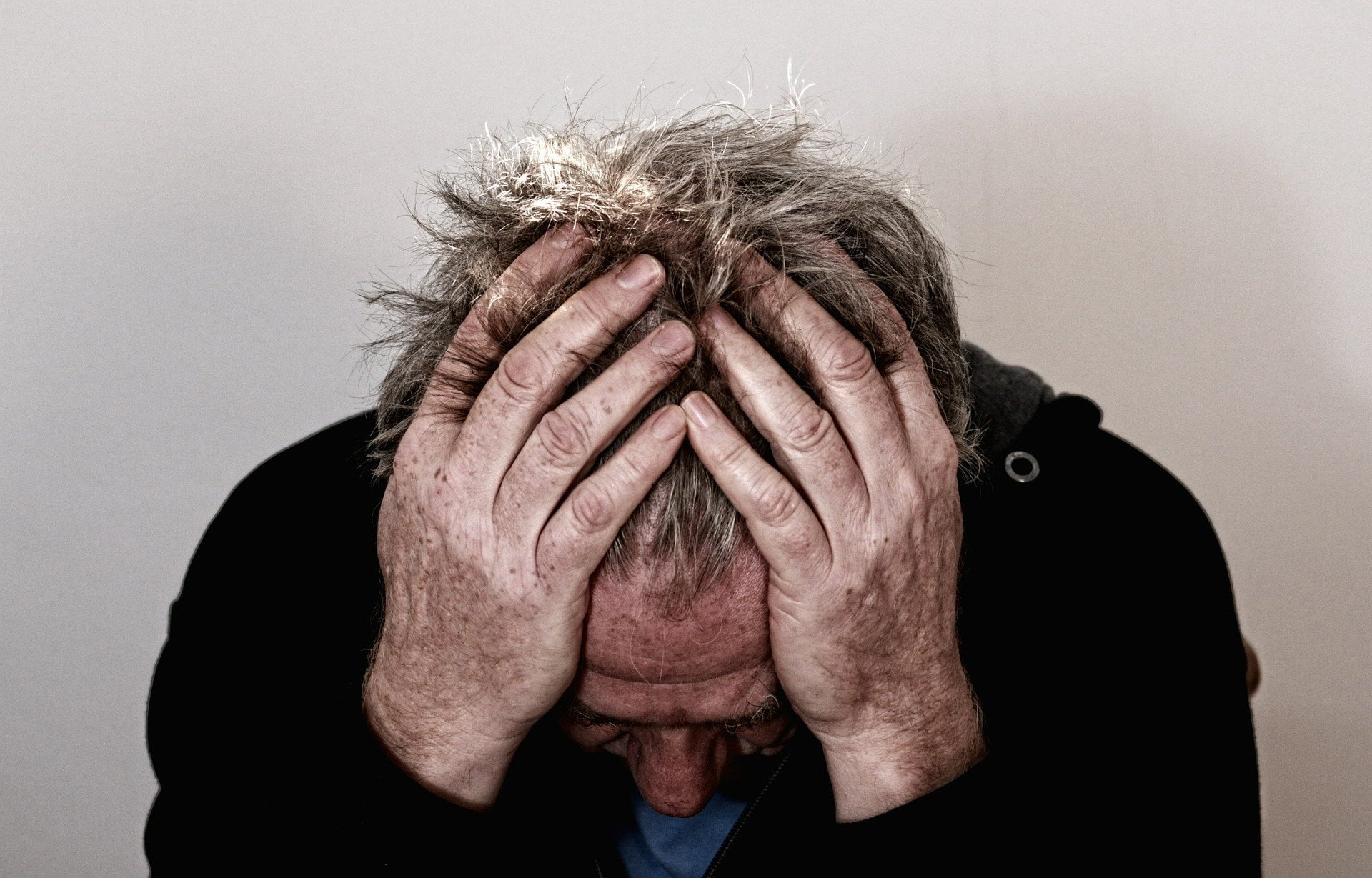 Man covering head