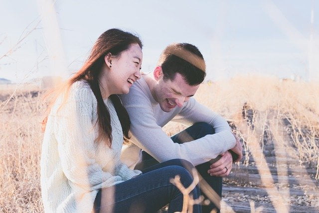 Couple sitting in a field in Hampshire