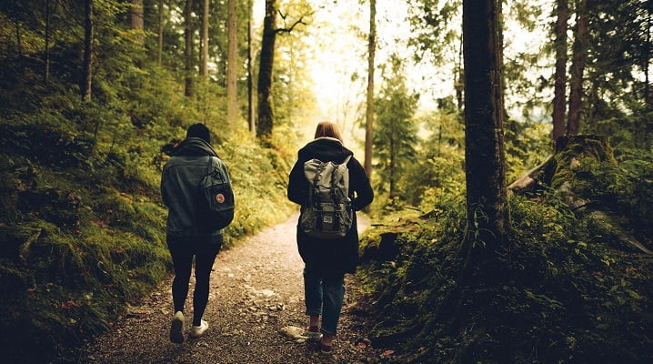 Two people walking in a woodland in Bedford