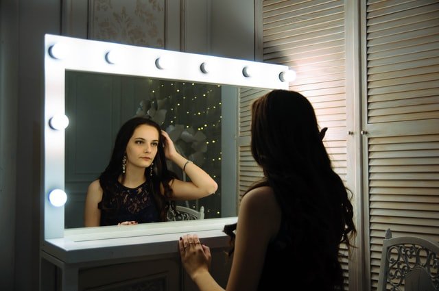 woman looking in mirror