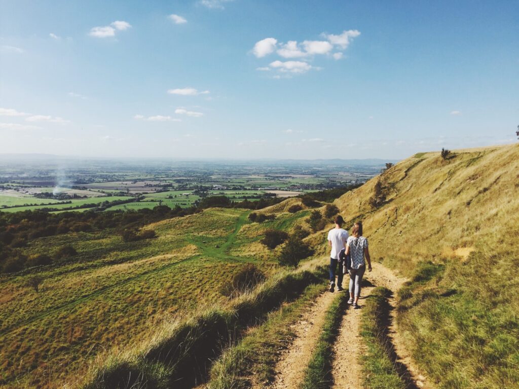 Couple walking along hillside 