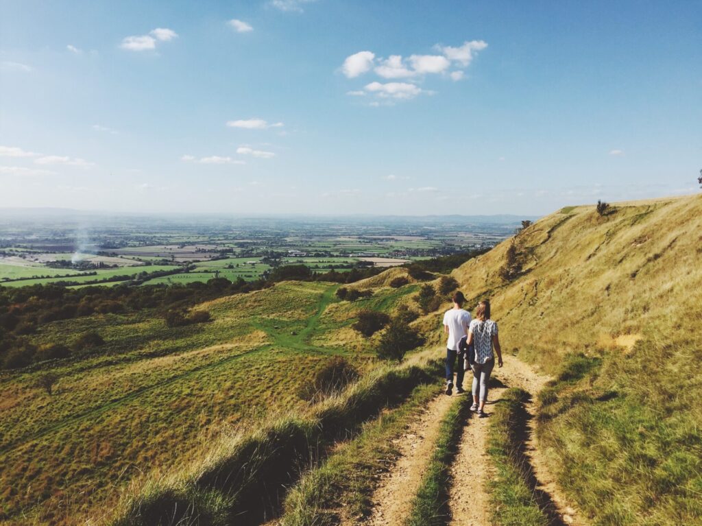 Couple walking along hillside