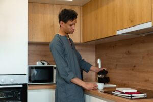 Man making coffee in kitchen