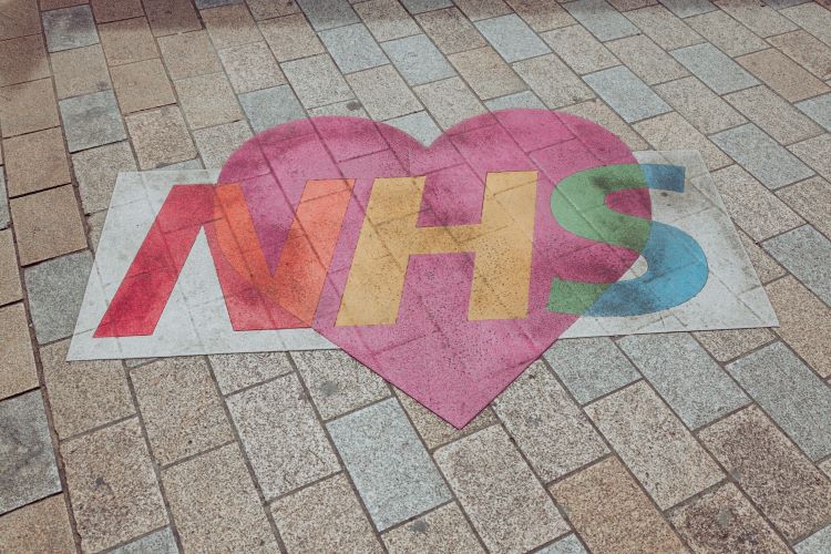 A path with an NHS sign and a heart through the middle