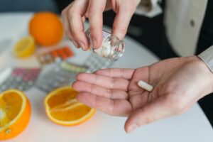 Person holding pills for detox at rehab in East Sussex