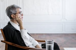 Therapist in formal dress sitting in a chair