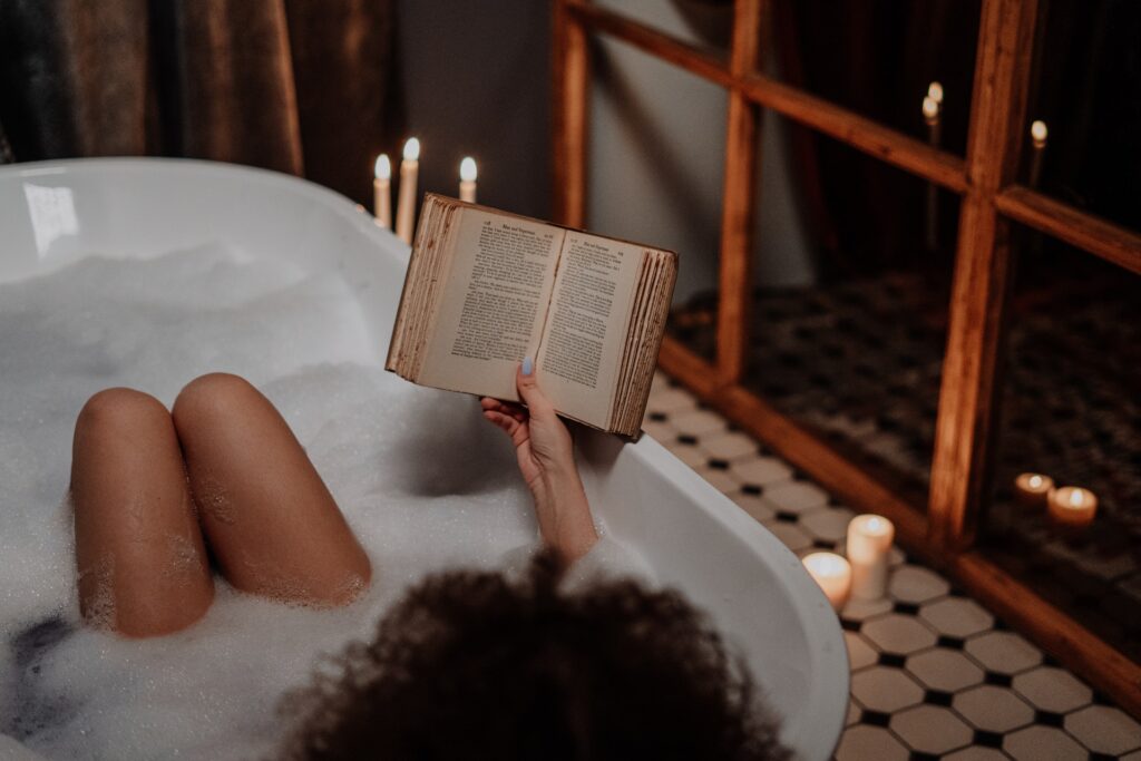 Woman in the bath reading a book