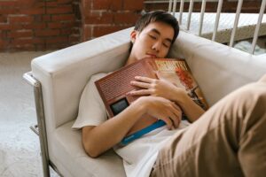 Young man asleep on sofa.