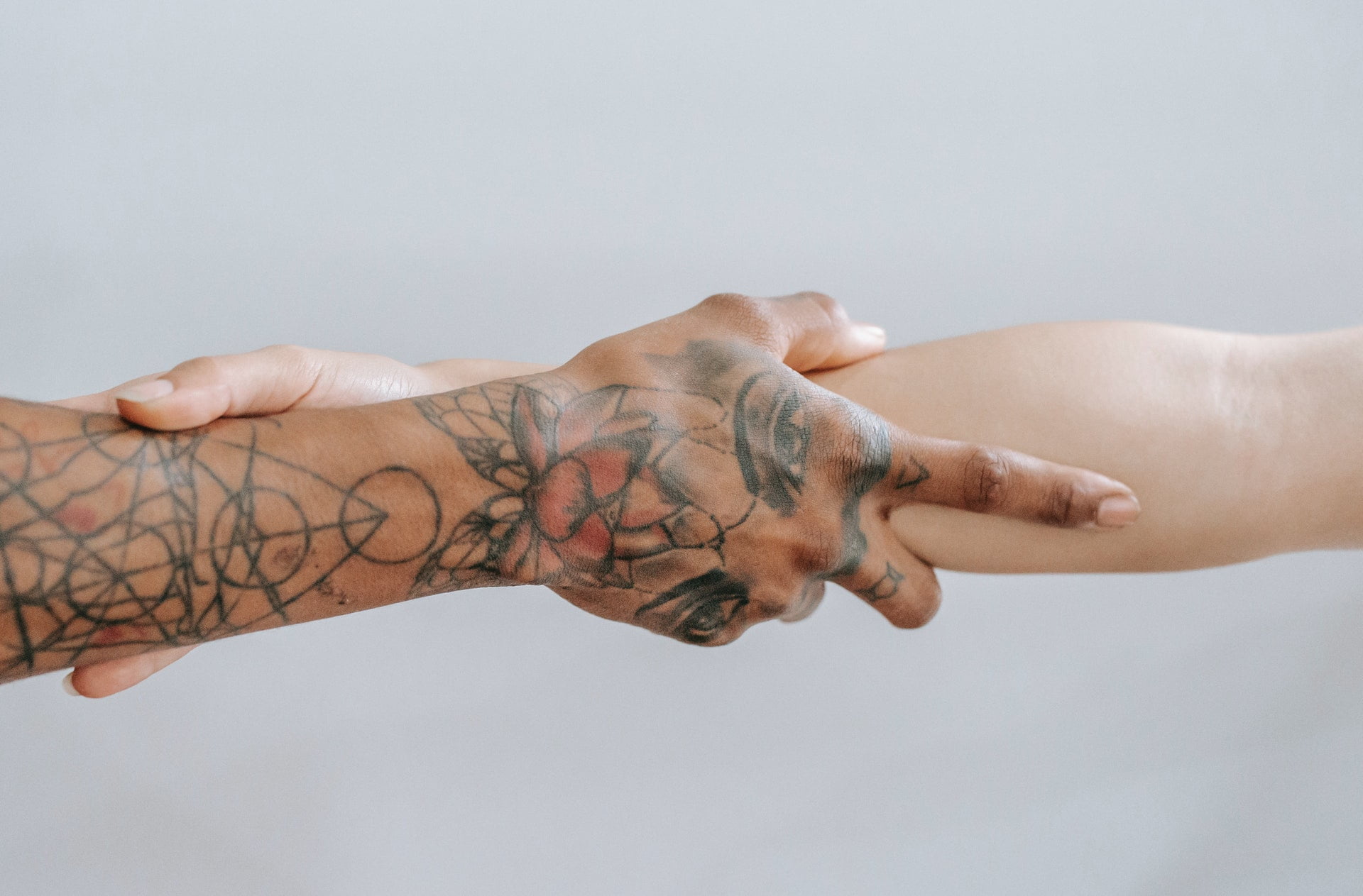 Patients clasping their arms together at a drug and alcohol rehab centre in East Sussex