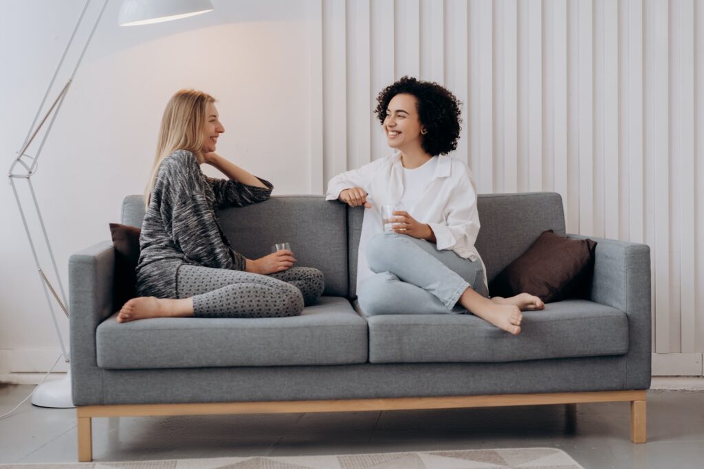 Two people sitting on a couch talking in Buckinghamshire