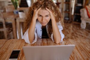 Woman looking puzzled at her laptop