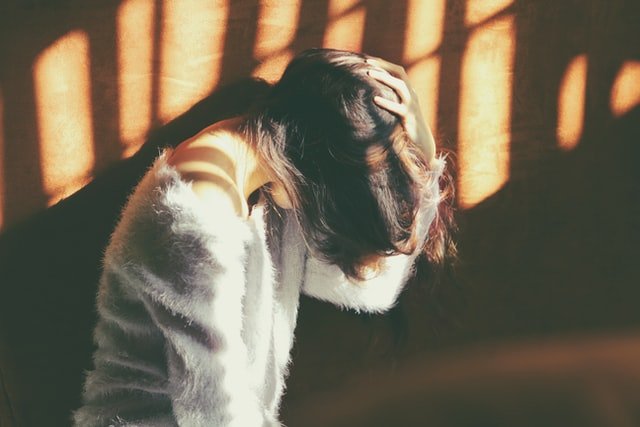 Woman with a headache at a drug rehab and alcohol rehab in Coventry or near Coventry