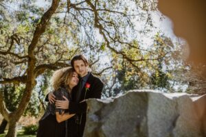 couple grieving together over grave