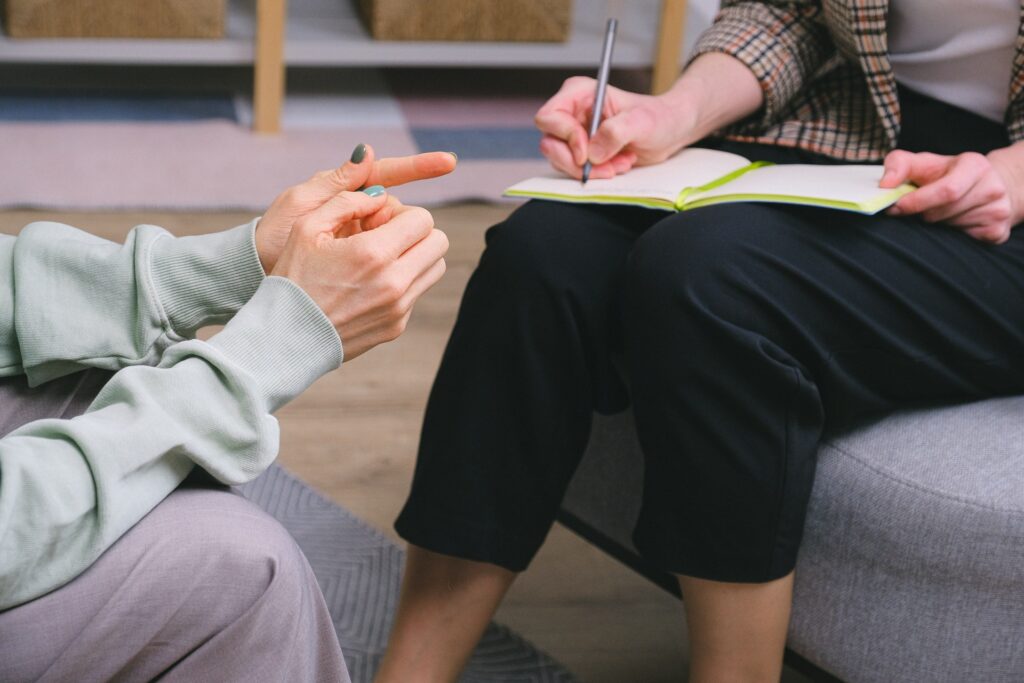 two people talking together on sofas