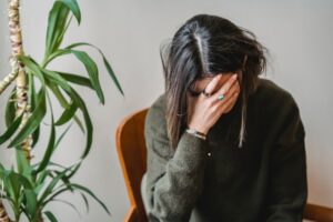 woman covering her face with her hand