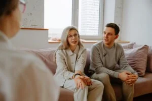 A man and a woman talking with a health professional