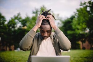 Man looking at his laptop distressed