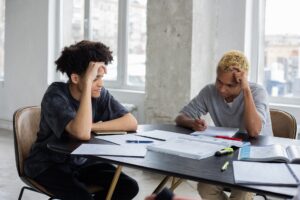 Two people sitting at a desk studying