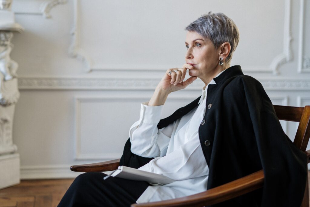 Woman sitting down looking thoughtful at a drug and alcohol rehab in Bristol or near Bristol