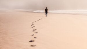 man walking into the desert